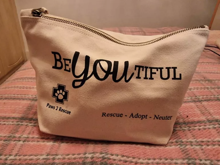 A photo of a vegan toiletry bag with the words "beYOUtiful" printed on the side.